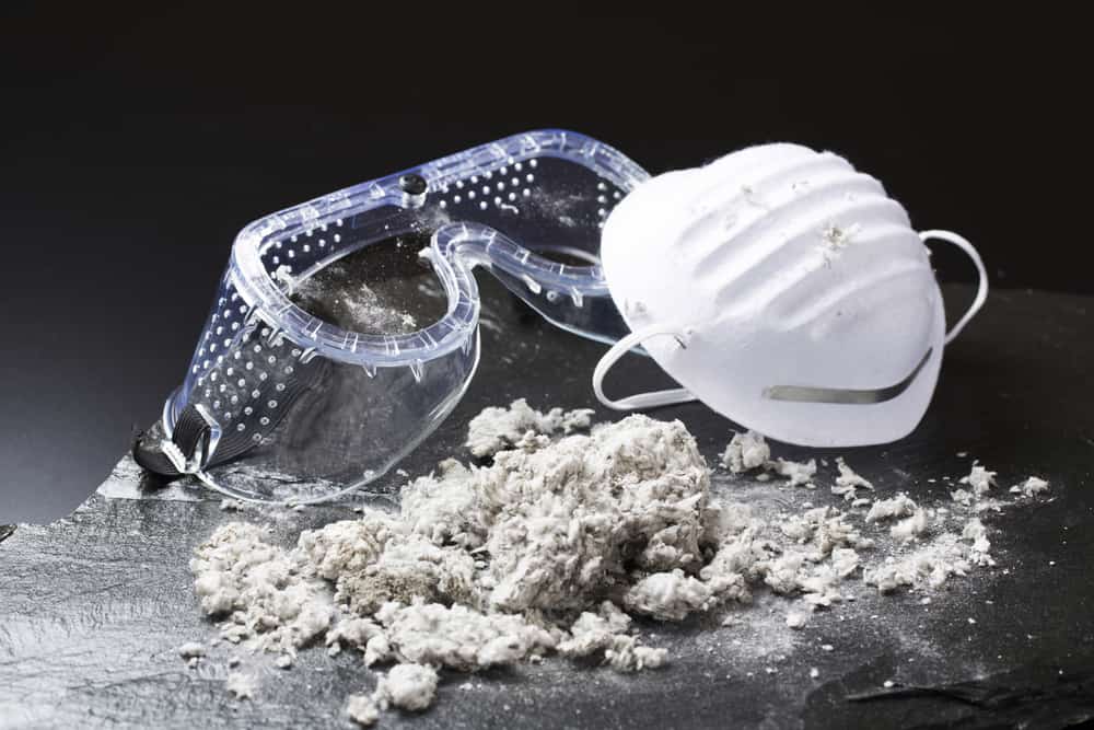 Asbestos removal appalchian contracting Safety goggles, dust mask and pile of asbestos dust
